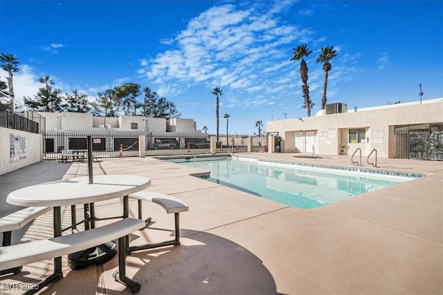 pool featuring a patio area and fence