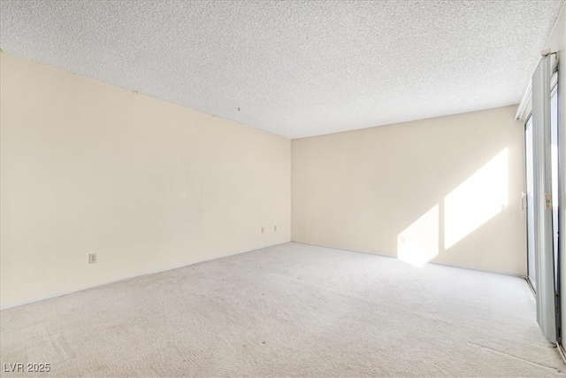 empty room featuring carpet and a textured ceiling