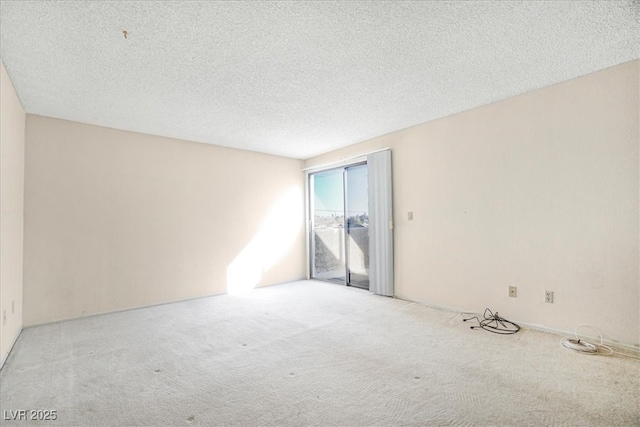 empty room featuring a textured ceiling and carpet flooring