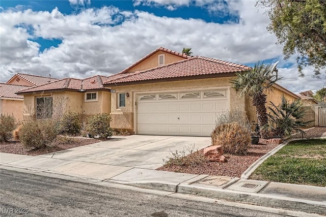 mediterranean / spanish-style house featuring stucco siding, a garage, driveway, and a tile roof