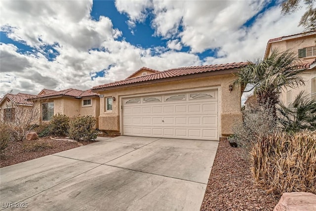 mediterranean / spanish home featuring a tiled roof, an attached garage, driveway, and stucco siding