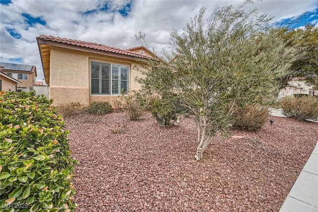 view of property exterior featuring stucco siding and a tiled roof