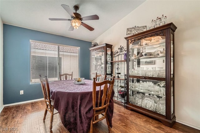 dining room featuring a ceiling fan, wood finished floors, and baseboards