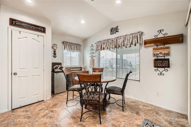 dining space with recessed lighting, baseboards, light tile patterned floors, and vaulted ceiling