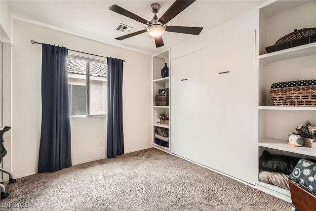 carpeted bedroom featuring a ceiling fan and visible vents