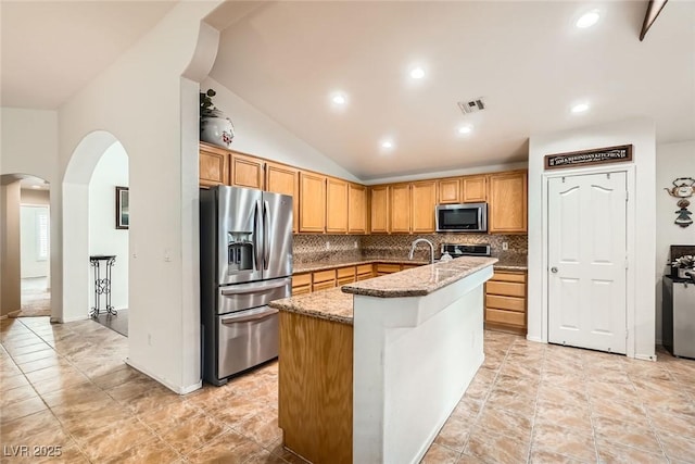 kitchen featuring light stone counters, visible vents, appliances with stainless steel finishes, and decorative backsplash