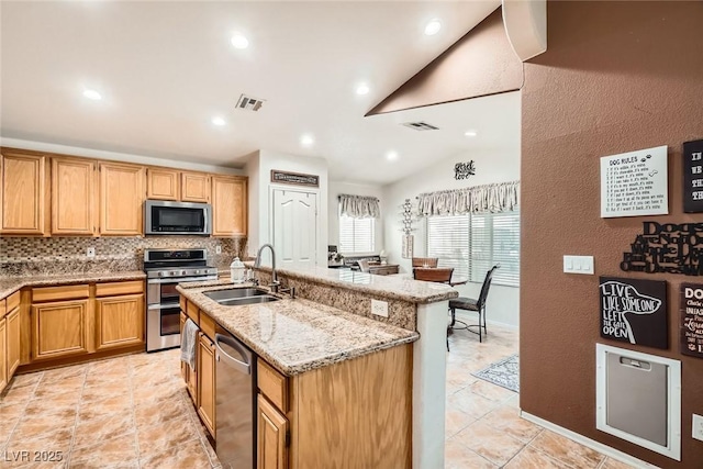 kitchen with a sink, visible vents, backsplash, and appliances with stainless steel finishes