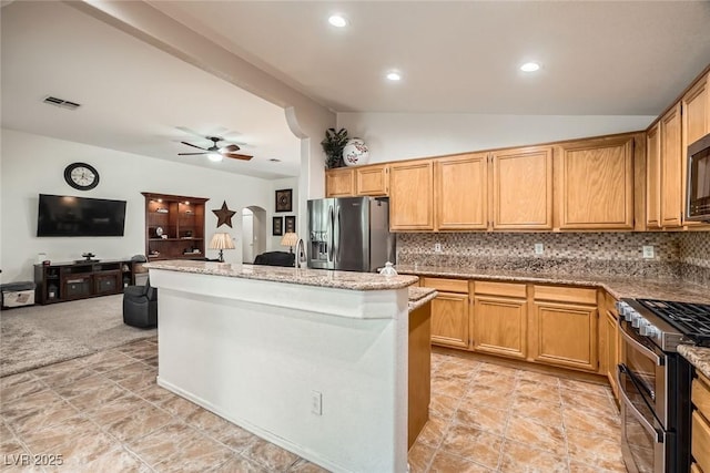 kitchen featuring visible vents, arched walkways, ceiling fan, vaulted ceiling, and appliances with stainless steel finishes