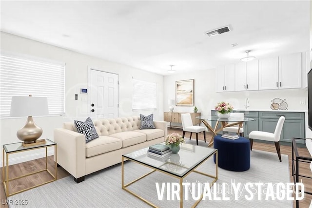 living room with visible vents and light wood finished floors