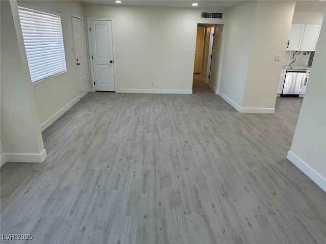 unfurnished room with recessed lighting, visible vents, light wood-style flooring, and baseboards