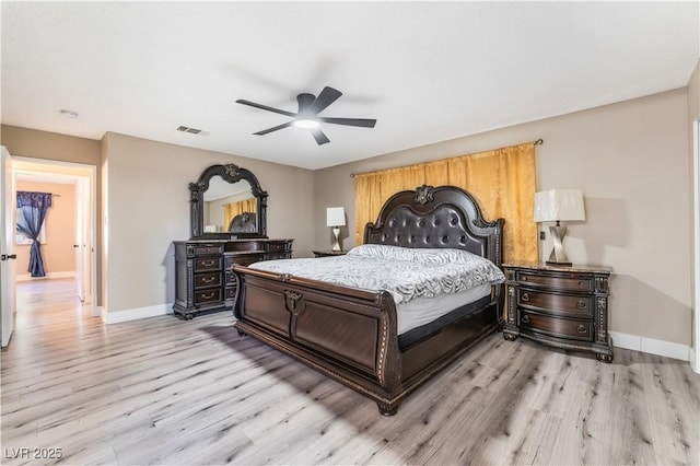 bedroom featuring visible vents, light wood-style flooring, and baseboards