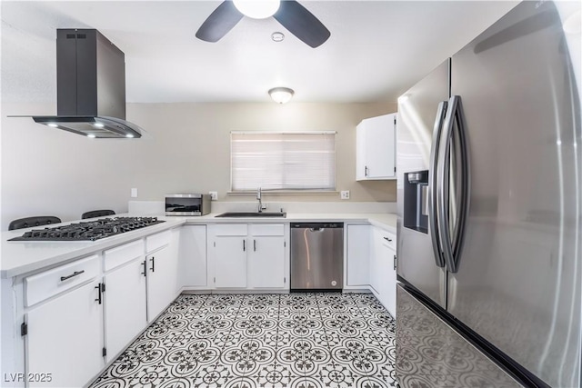 kitchen with stainless steel appliances, light countertops, a sink, and island range hood