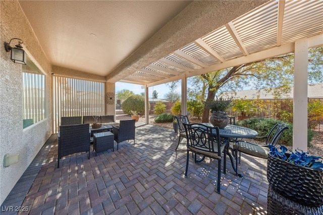 view of patio with fence, outdoor dining area, and a pergola