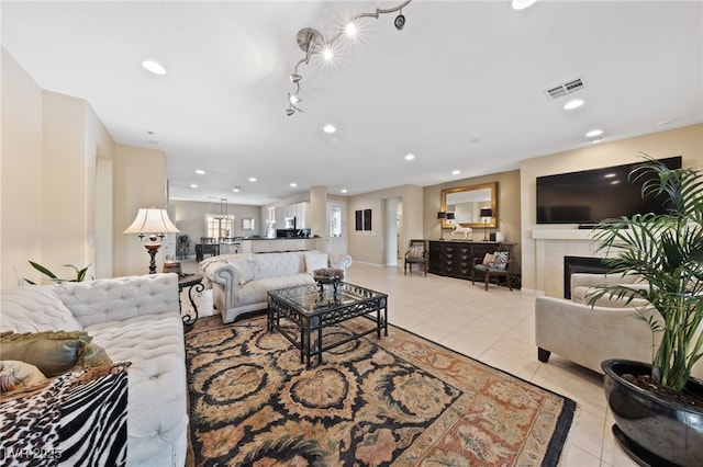 living area with recessed lighting, visible vents, and light tile patterned flooring