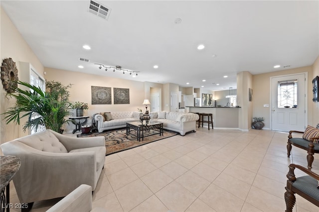 living room featuring light tile patterned floors, visible vents, and recessed lighting