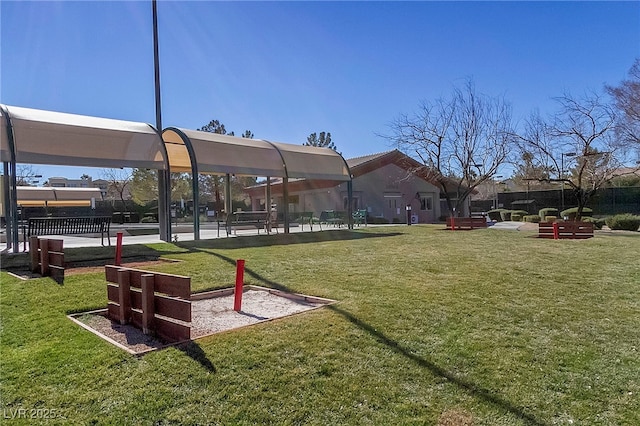 view of home's community featuring fence and a yard