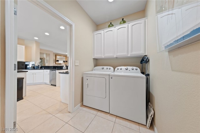 washroom with recessed lighting, cabinet space, light tile patterned flooring, separate washer and dryer, and baseboards