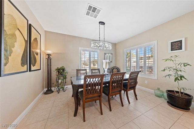 dining area with light tile patterned floors, plenty of natural light, visible vents, and baseboards