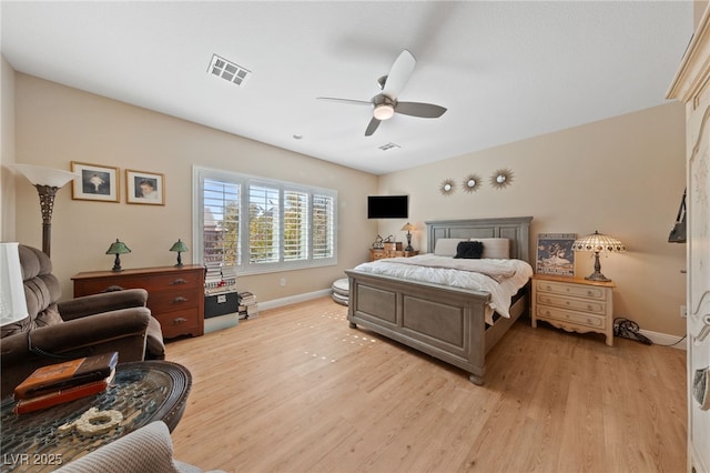 bedroom with visible vents, ceiling fan, light wood-style flooring, and baseboards