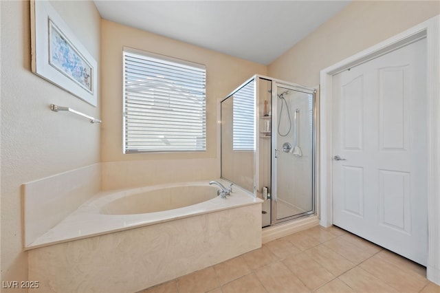 full bath featuring a stall shower, a bath, and tile patterned floors