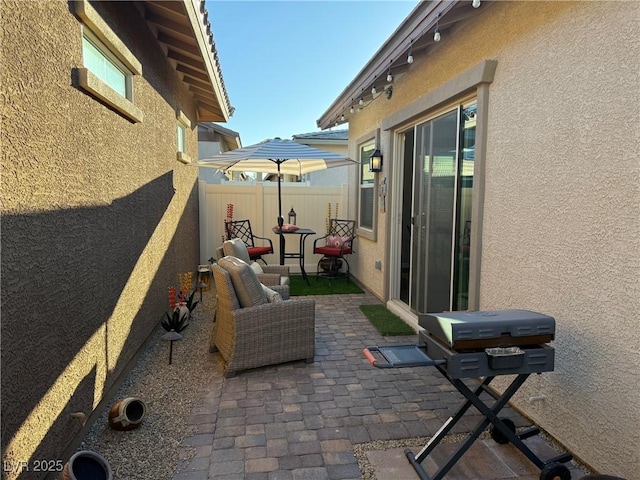 view of patio with fence and grilling area