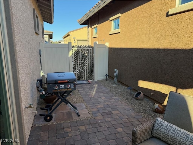 view of patio / terrace with area for grilling and fence