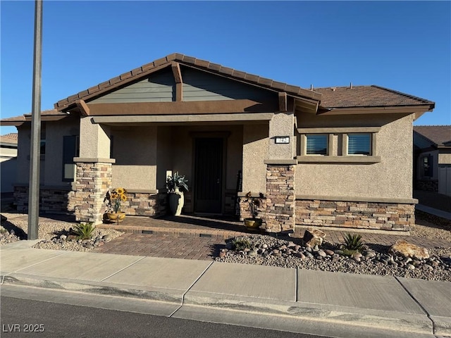 view of front of property featuring stone siding and stucco siding