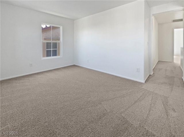 carpeted spare room with baseboards and visible vents