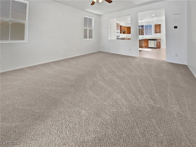 unfurnished living room with light carpet and ceiling fan