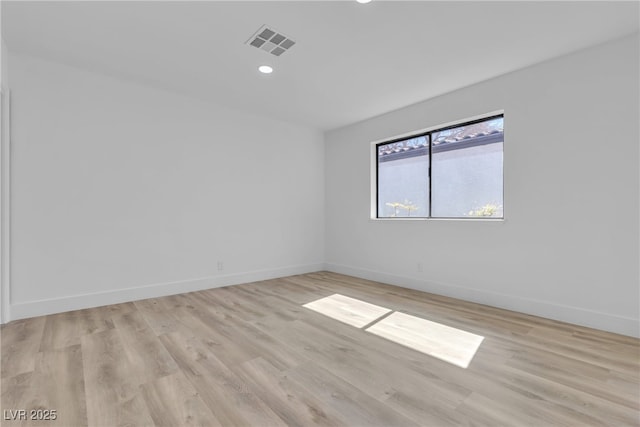 empty room featuring recessed lighting, visible vents, light wood-style flooring, and baseboards