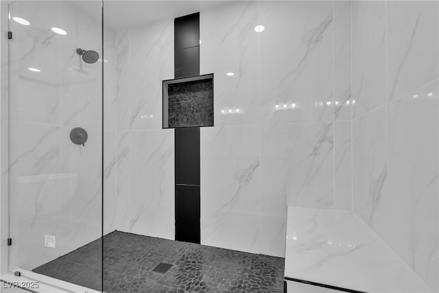 full bathroom with a marble finish shower