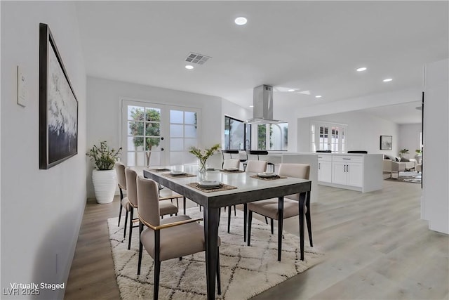 dining area with light wood-style floors, recessed lighting, visible vents, and french doors