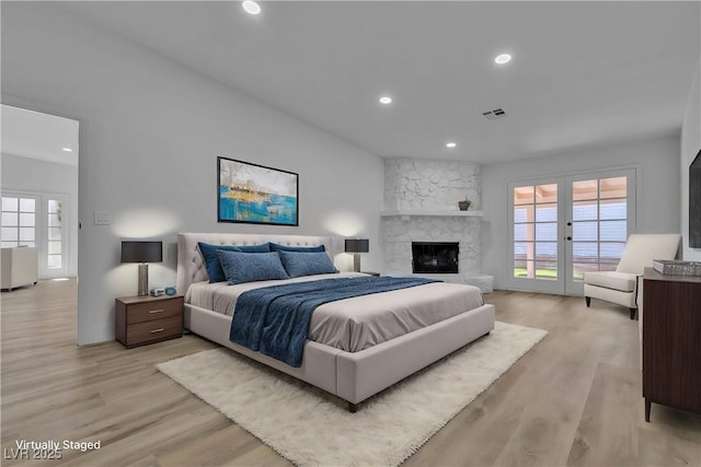 bedroom featuring access to exterior, french doors, visible vents, and light wood-style floors