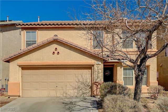 view of front facade with stucco siding, driveway, and a garage