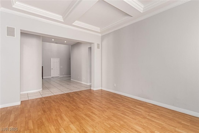 spare room featuring crown molding, coffered ceiling, baseboards, and light wood-style floors