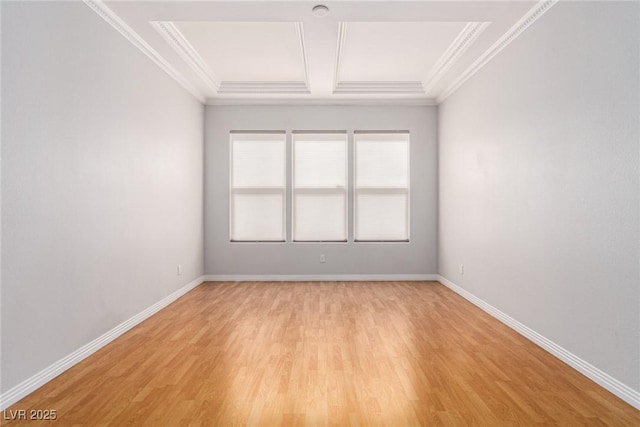 empty room with light wood-style floors, baseboards, coffered ceiling, and ornamental molding