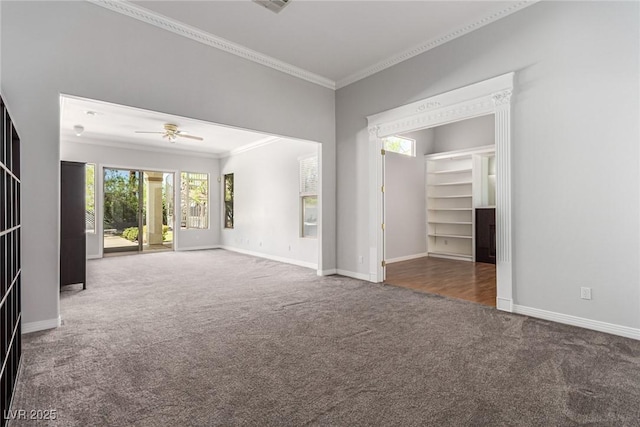 unfurnished living room featuring crown molding, baseboards, ceiling fan, and carpet flooring