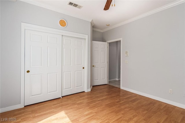 unfurnished bedroom with baseboards, visible vents, and light wood-style floors