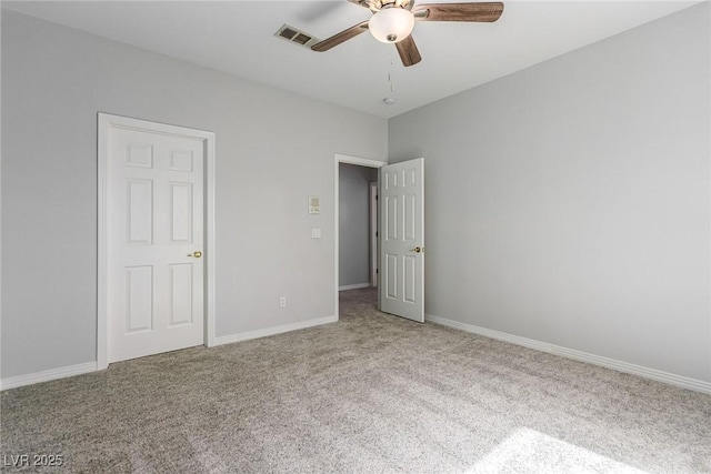 unfurnished bedroom featuring carpet floors, baseboards, visible vents, and a ceiling fan