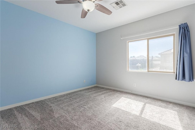 carpeted empty room with baseboards, visible vents, and a ceiling fan