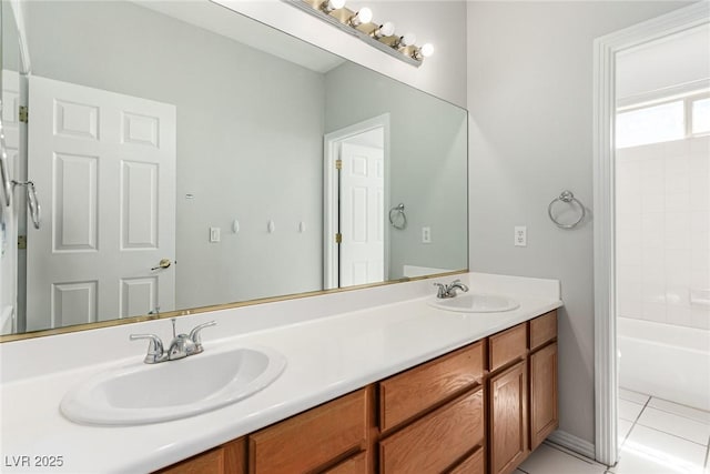 bathroom with double vanity, a sink, and tile patterned floors