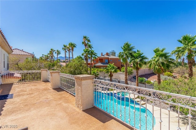 view of swimming pool with a pool with connected hot tub