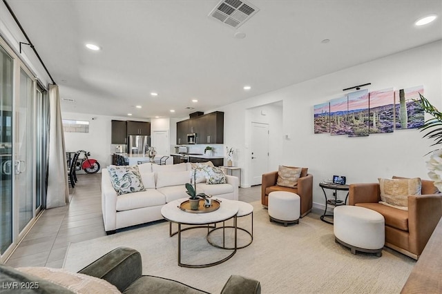 living area with recessed lighting and visible vents