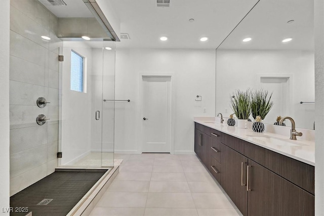 full bathroom featuring tile patterned floors, a sink, a shower stall, and double vanity