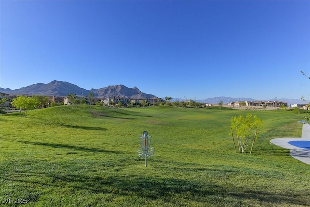 view of property's community featuring a mountain view and a yard