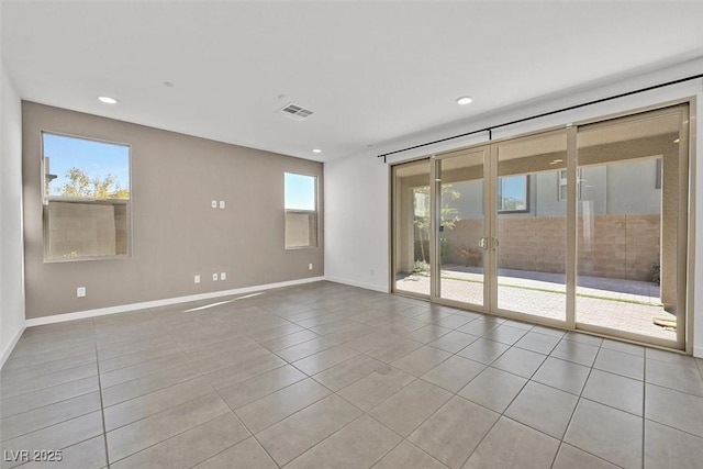 spare room with recessed lighting, baseboards, and tile patterned floors