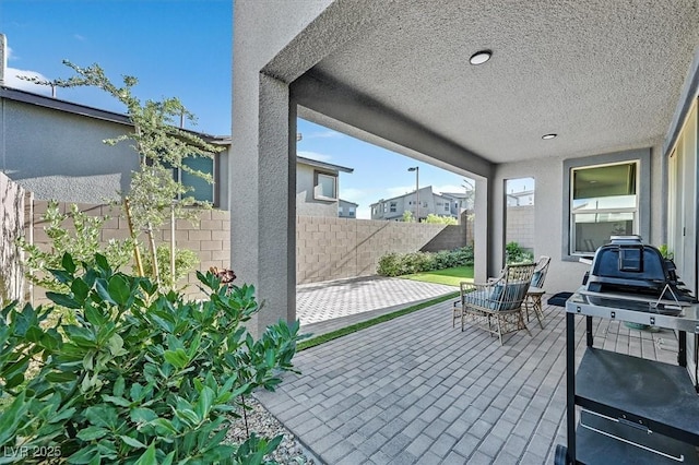 view of patio / terrace featuring fence