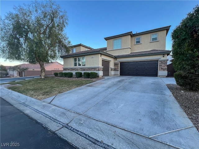 view of front of home with stucco siding, a front yard, a garage, stone siding, and driveway