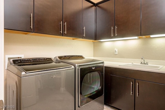 washroom with separate washer and dryer, a sink, and cabinet space