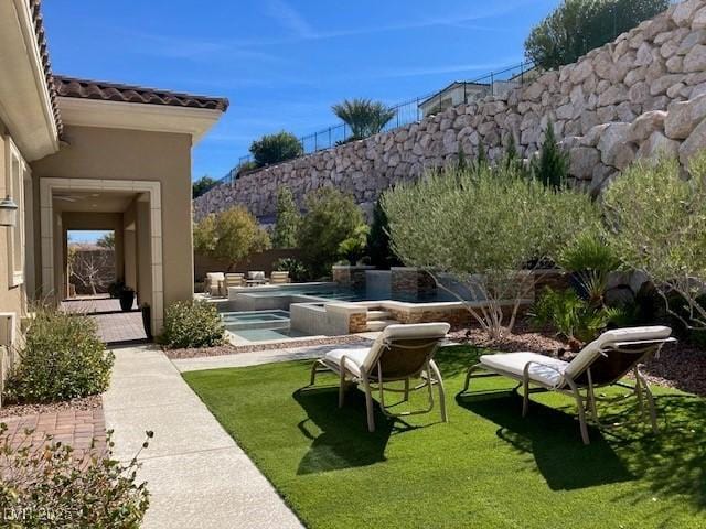 view of yard featuring an outdoor pool, a patio, and fence